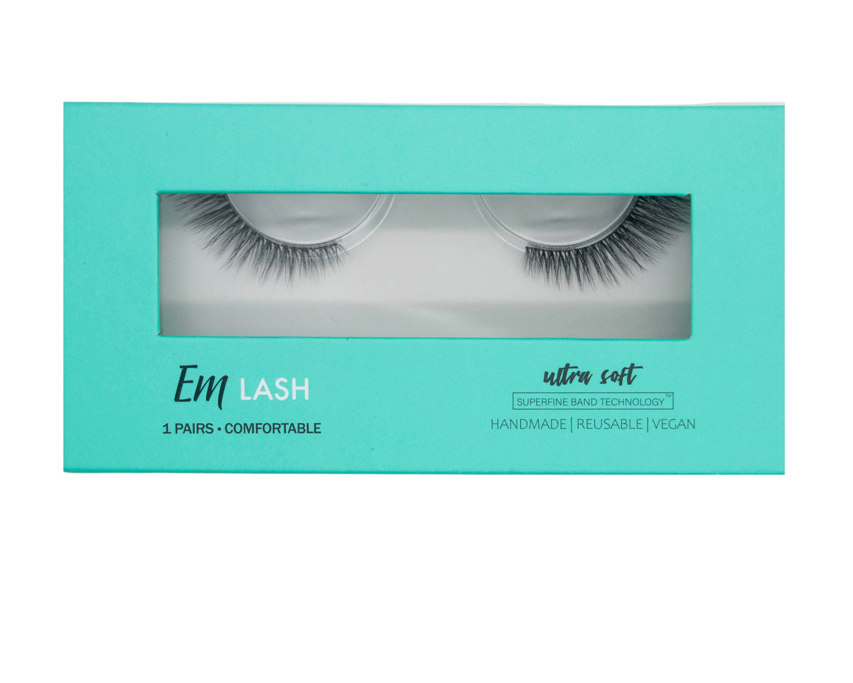 Em Lash ultra soft false eyelashes in a mint green rectangular box with a clear window showing the lashes inside, on a solid gray background.