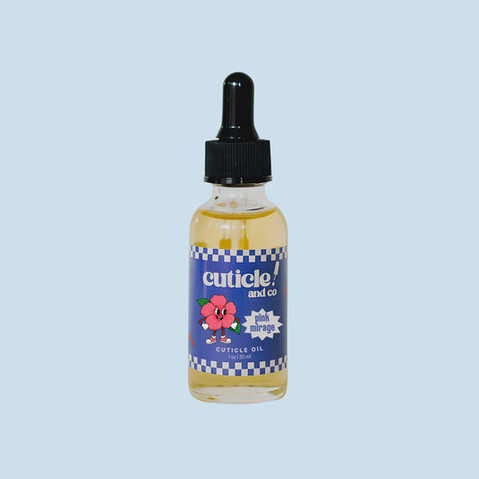 A small glass dropper bottle of cuticle oil with a black dropper cap and a blue label reading 'cuticle! and co' and 'pink blossom', centered on a light blue background.