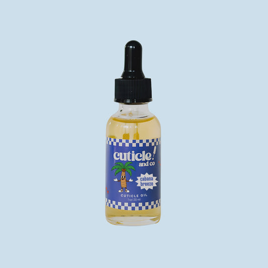 A small clear bottle of Cuticle and Co. Cabotian Breeze Peticle Oil with a black dropper cap, set against a solid light blue background.