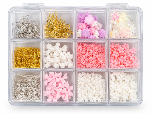A clear plastic organizer tray with 12 compartments, filled with assorted craft embellishments including metallic silver and gold stars, pink and white flower charms, beads, and small decorative pieces, shown on a white background.
