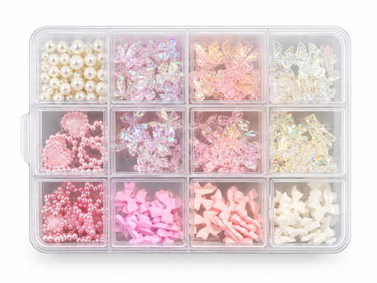 A clear plastic organizer tray with 12 compartments filled with assorted craft embellishments, including faux pearls, iridescent flower pieces, pink and white decorative elements, and small white star-shaped pieces, shown on a white background.