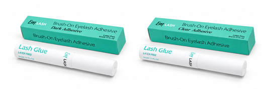 Two white tubes of Lash Glue with teal and white packaging boxes, shown on a clean white background. The packaging text indicates 'Brush-On Eyelash Adhesive' in two variants: 'Dark-Adhesive' and 'Clear-Adhesive'.