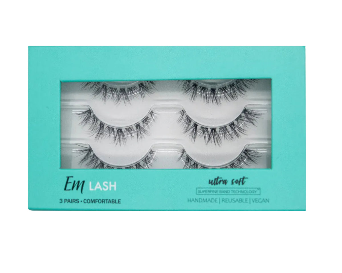 Em Lash Ultra Soft 3-pair set of false eyelashes in a turquoise window box package, shown against a neutral gray background.
