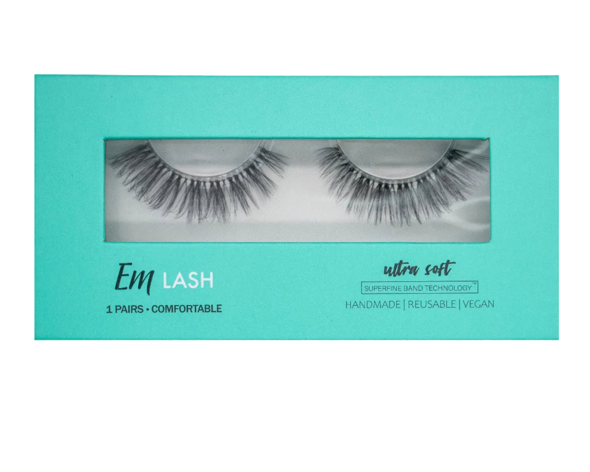 Em Lash ultra soft false eyelashes in a turquoise rectangular box, shown against a neutral gray background.