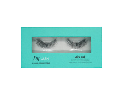 Em Lash Ultra Coft false eyelashes in a turquoise window box packaging, shown against a neutral gray background.