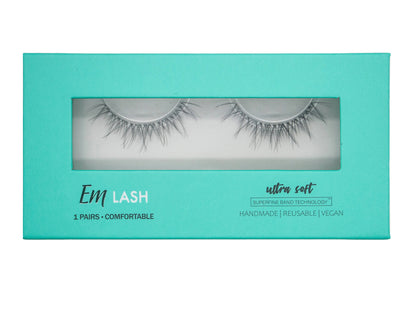 Em Lash false eyelashes in a turquoise rectangular box with a clear window showing the lashes inside, on a light gray background.